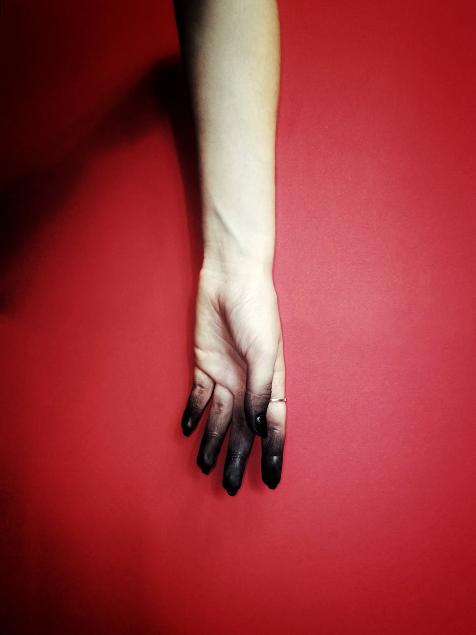 a white hand on the red background